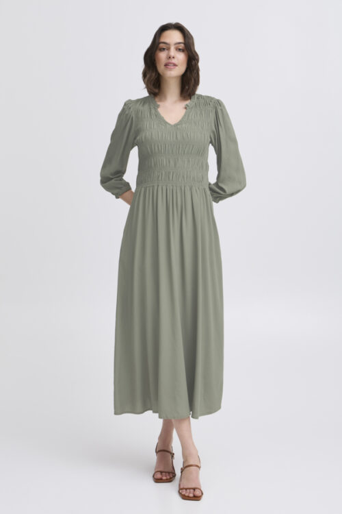 The Lalu Puckered V-Neck Dress is a mid-length style made from soft, stretchy material. Its flattering V-neck and puckered texture offer a comfortable, stylish fit for any occasion.